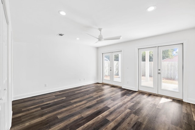 spare room with dark wood-type flooring, ceiling fan, and french doors