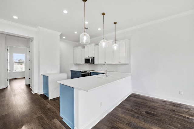 kitchen with stainless steel appliances, white cabinetry, pendant lighting, and kitchen peninsula