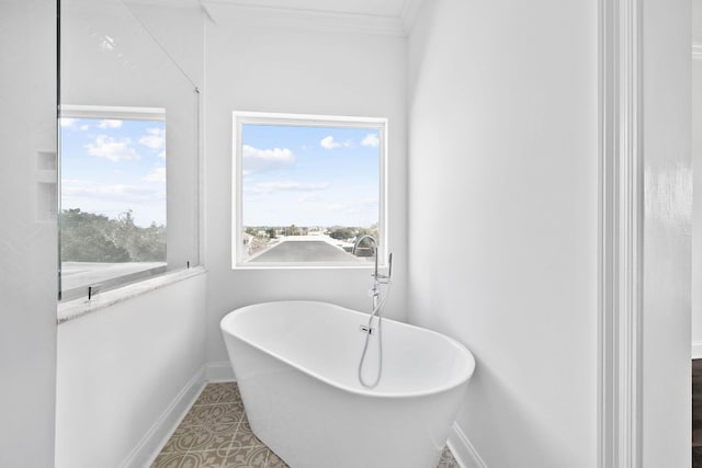 bathroom featuring crown molding, tile patterned floors, and a bathing tub