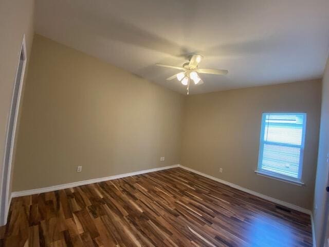 empty room featuring ceiling fan and dark hardwood / wood-style flooring