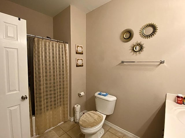 bathroom with tile patterned flooring, vanity, and toilet