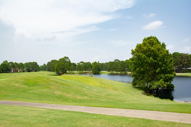 surrounding community featuring a water view and a yard