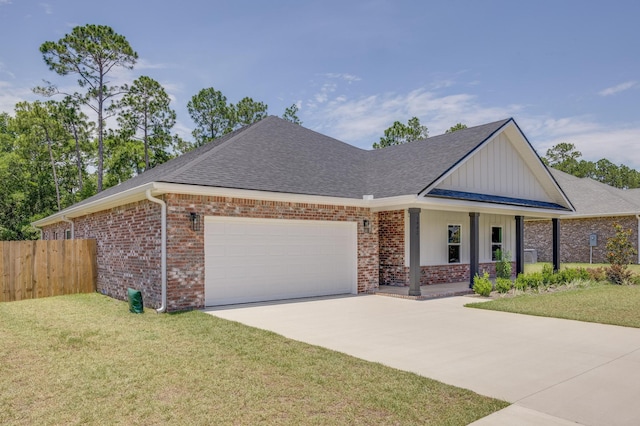 view of front of home with a porch, a garage, and a front yard