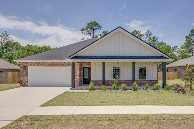 view of front facade featuring a garage, covered porch, and a front yard