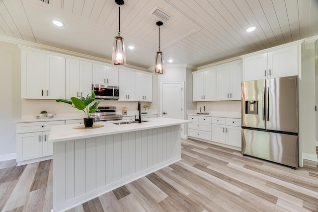 kitchen with pendant lighting, sink, white cabinetry, and stainless steel appliances