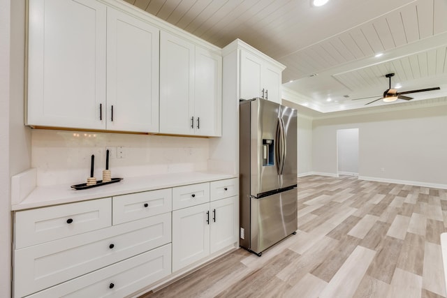 kitchen featuring stainless steel refrigerator with ice dispenser, light hardwood / wood-style flooring, wooden ceiling, ceiling fan, and white cabinets