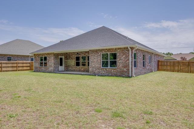 back of property featuring a yard and a patio area