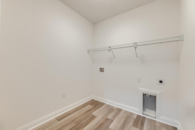 laundry room with hookup for an electric dryer, hookup for a washing machine, and light wood-type flooring