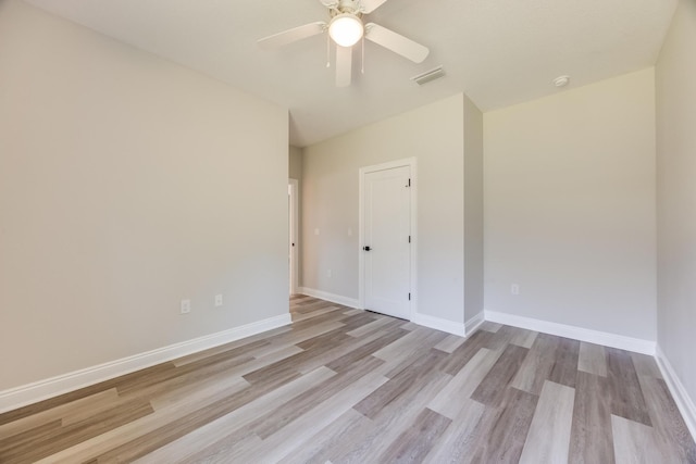 empty room featuring ceiling fan and light hardwood / wood-style floors