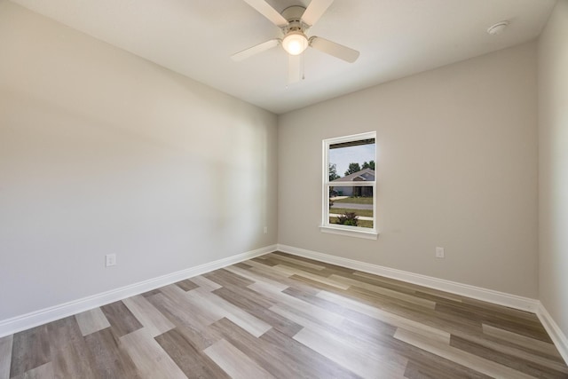 spare room featuring light hardwood / wood-style flooring and ceiling fan