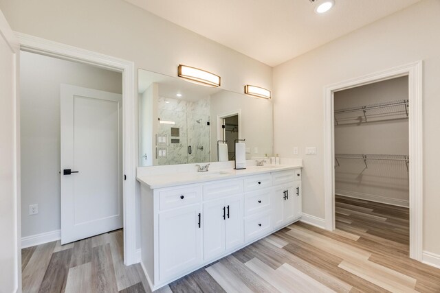 bathroom with vanity, an enclosed shower, and hardwood / wood-style floors