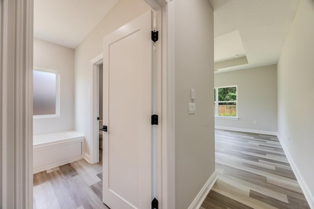 corridor with light hardwood / wood-style floors