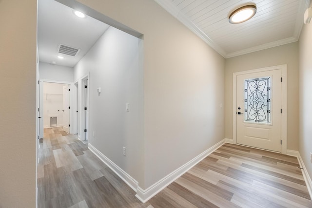 entrance foyer featuring crown molding and light hardwood / wood-style floors