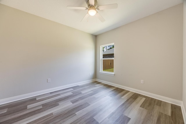 empty room featuring wood-type flooring and ceiling fan