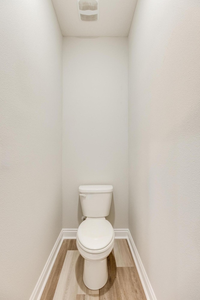 bathroom featuring toilet and hardwood / wood-style floors