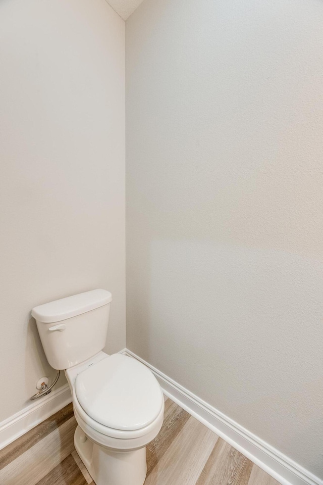 bathroom featuring hardwood / wood-style floors and toilet