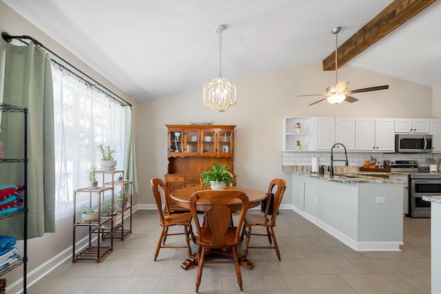 dining room with lofted ceiling with beams, ceiling fan with notable chandelier, sink, and light tile patterned floors