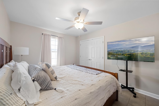 bedroom with tile patterned floors, ceiling fan, and a closet