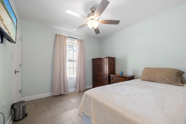 bedroom with ceiling fan and light tile patterned floors