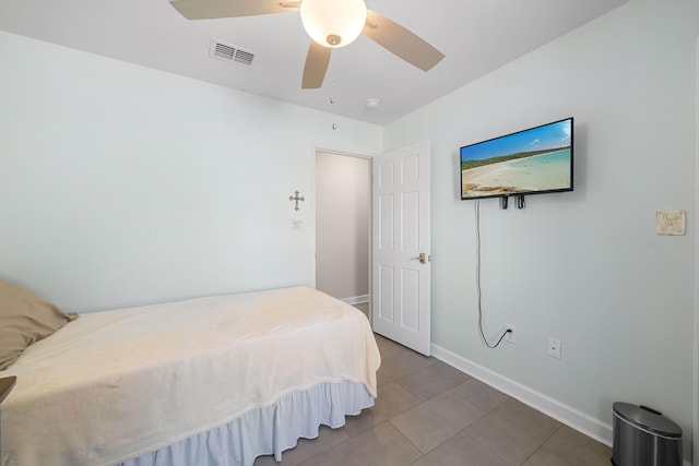 tiled bedroom with ceiling fan