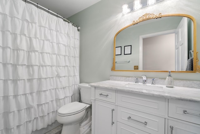 bathroom featuring vanity, toilet, and walk in shower