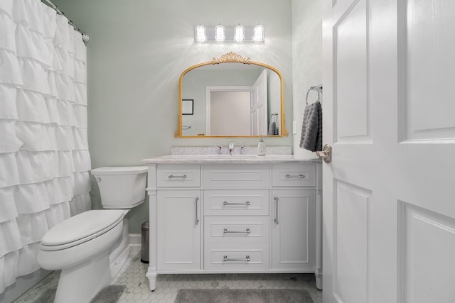 bathroom with vanity, tile patterned flooring, and toilet