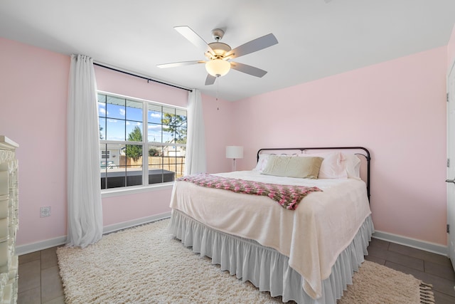 tiled bedroom featuring ceiling fan