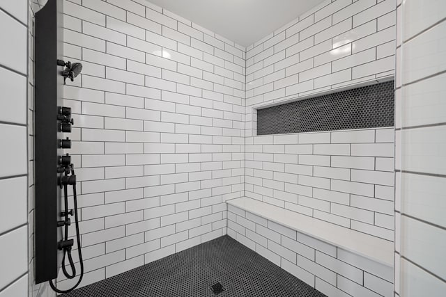 bathroom with tiled shower