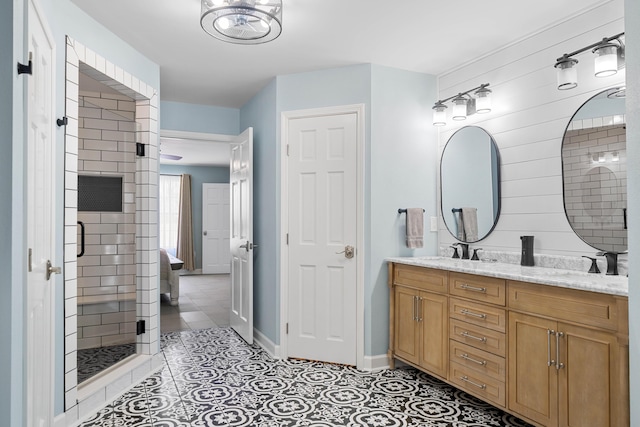 bathroom featuring vanity, a shower with shower door, and tile patterned flooring