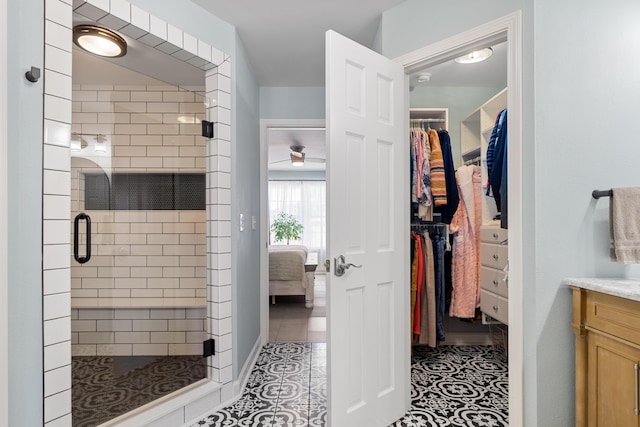 bathroom featuring vanity, tile patterned floors, and a shower with shower door