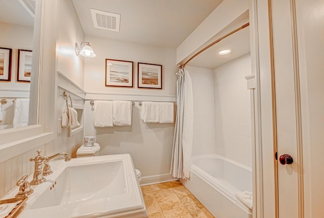 full bathroom with shower / tub combo with curtain, sink, and toilet