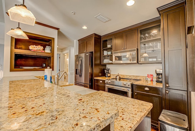 kitchen featuring stainless steel appliances, dark brown cabinets, and decorative light fixtures