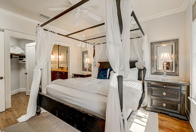 bedroom featuring crown molding, ceiling fan, and light hardwood / wood-style flooring