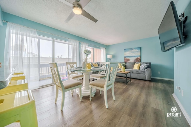 dining space featuring ceiling fan, hardwood / wood-style flooring, and a textured ceiling