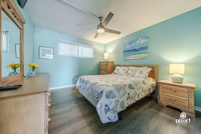 bedroom with ceiling fan, dark hardwood / wood-style flooring, and a textured ceiling