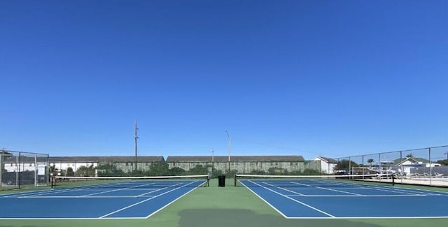 view of tennis court featuring basketball hoop