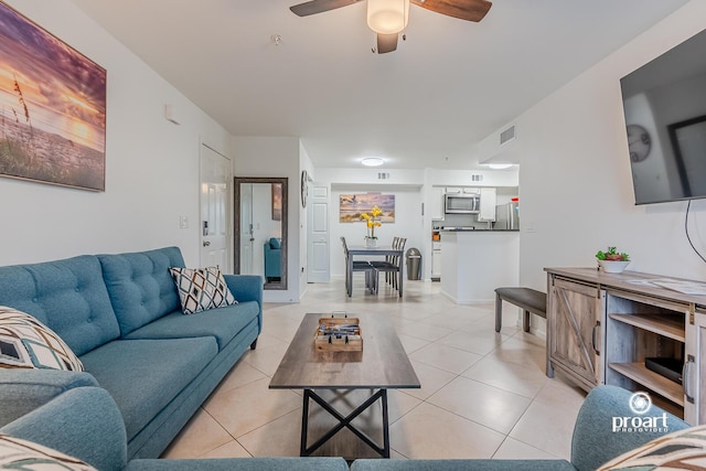 tiled living room with ceiling fan