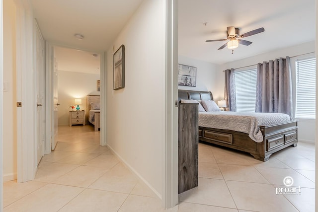 bedroom with ceiling fan and light tile patterned floors