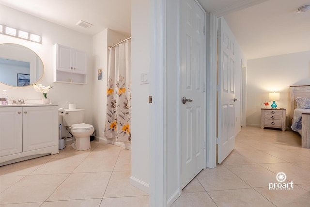 bathroom featuring tile patterned flooring, vanity, and toilet