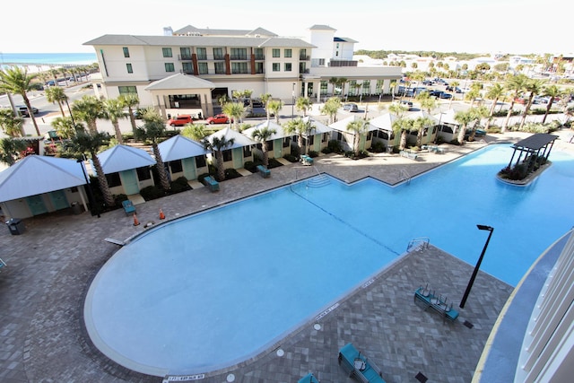 view of pool featuring a gazebo and a water view