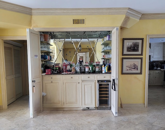 bar with ornamental molding, wine cooler, and dark stone counters