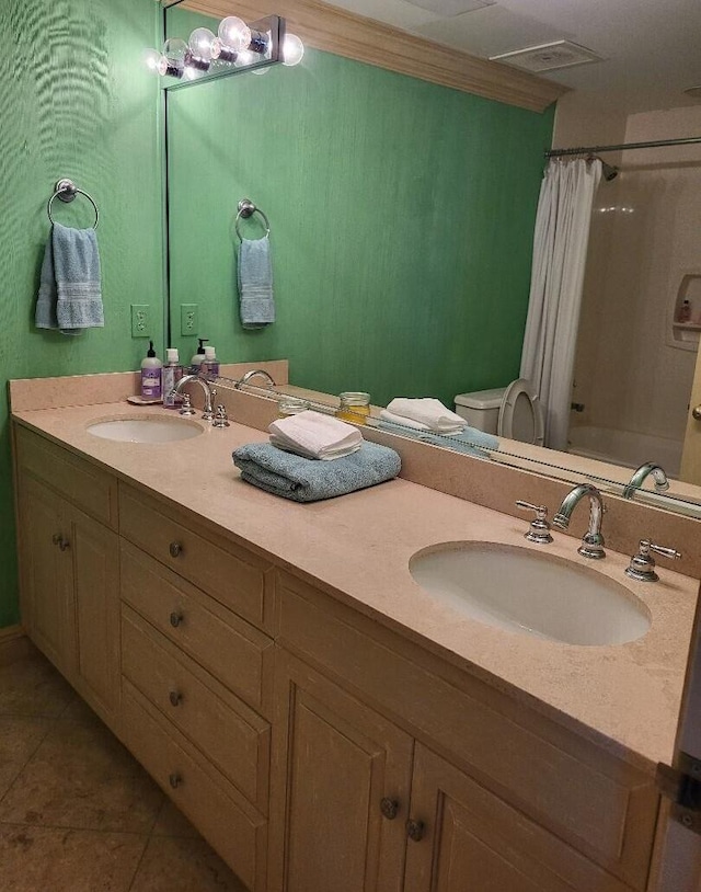 full bathroom featuring tile patterned floors, toilet, vanity, and shower / bath combo