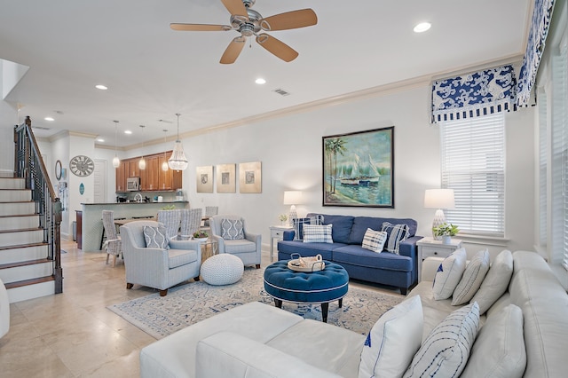 living room featuring ornamental molding and ceiling fan