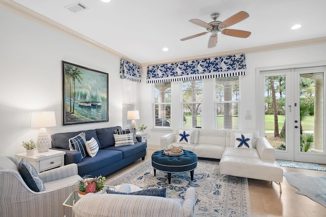 living room featuring ornamental molding, french doors, and ceiling fan