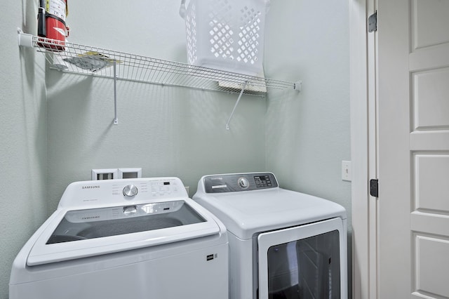 clothes washing area featuring separate washer and dryer