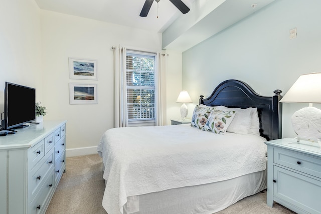 bedroom featuring light colored carpet and ceiling fan