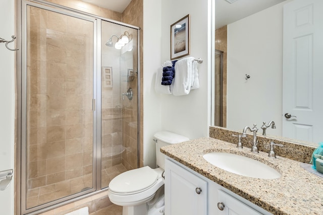 bathroom with tile patterned flooring, vanity, an enclosed shower, and toilet