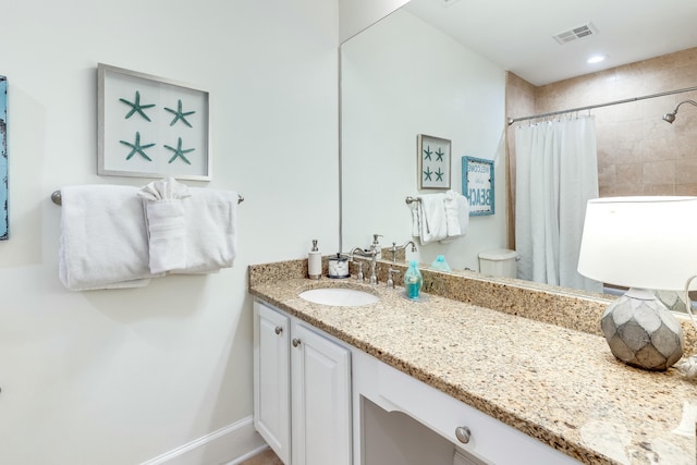 bathroom featuring vanity, toilet, and curtained shower