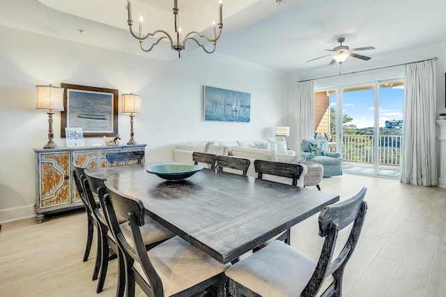 dining space featuring ceiling fan with notable chandelier, ornamental molding, and light hardwood / wood-style floors