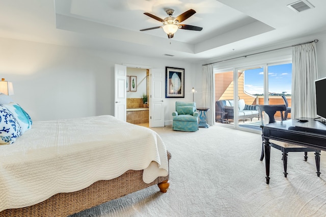 bedroom featuring ceiling fan, access to exterior, carpet flooring, connected bathroom, and a raised ceiling